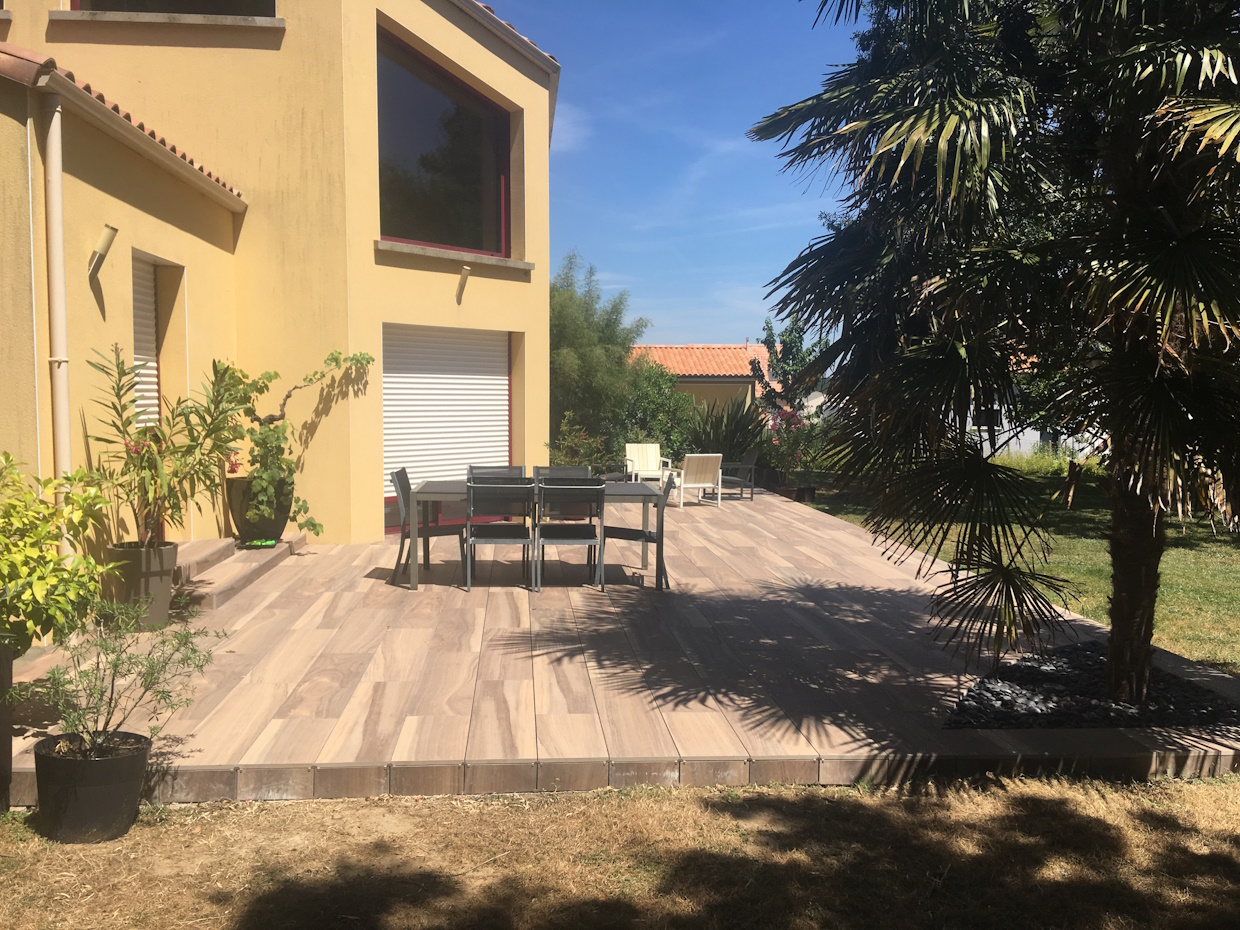 Terrasse en bois avec mobilier de jardin moderne.