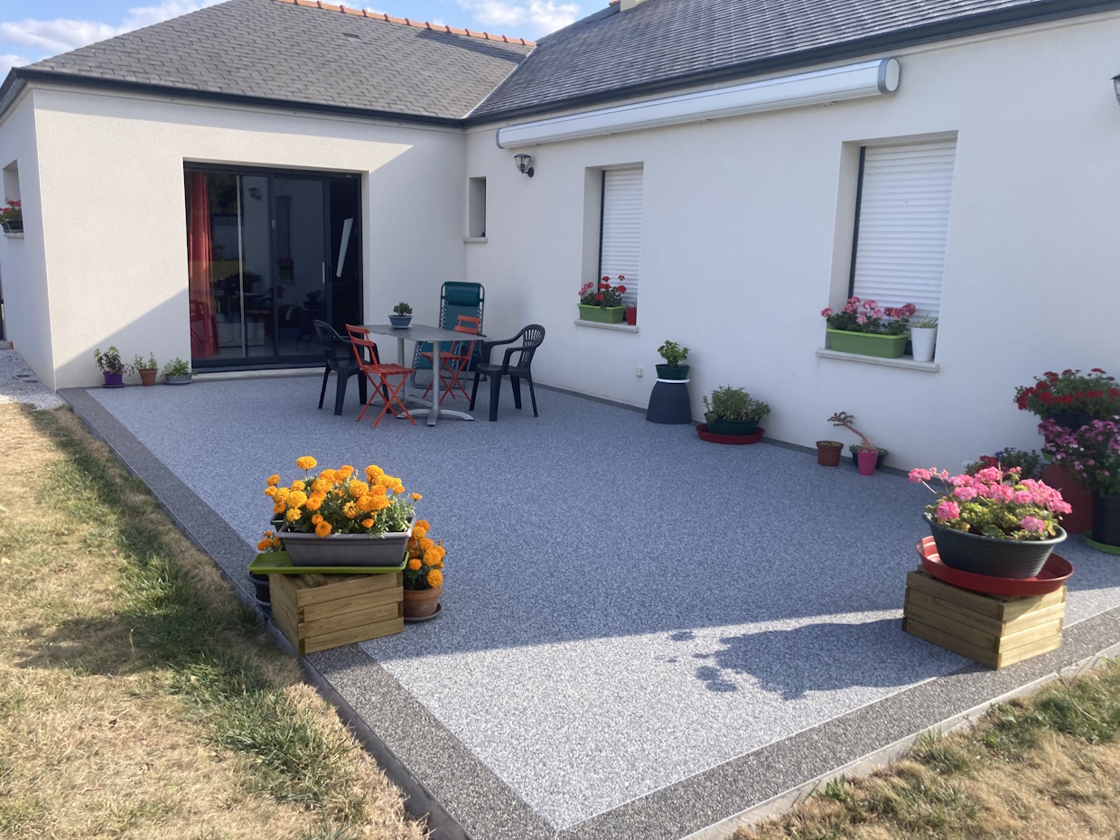 Terrasse moderne avec mobilier de jardin et plantes.